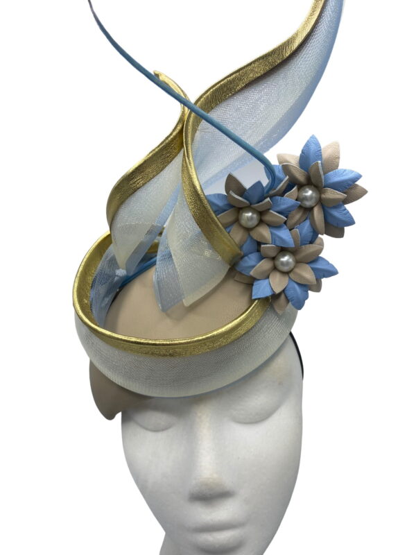 Stunning nude leather teardrop shaped headpiece with baby blue and nude handmade flowers and gold trim detail to finish.